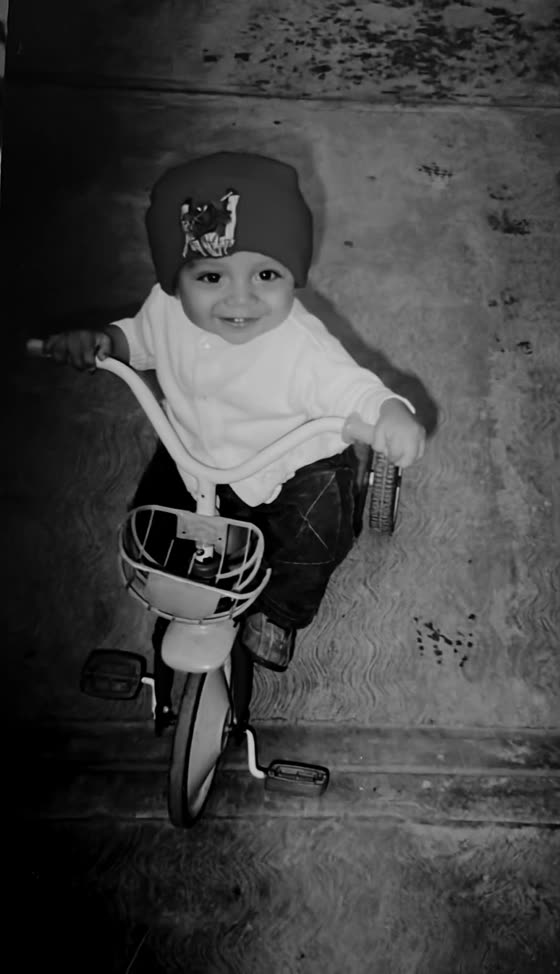 A baby riding a tricycle